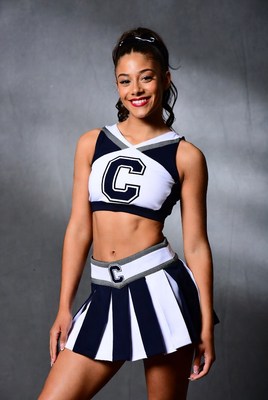 Cheerleader in stylish uniform posing