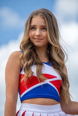 Cheerleader posing under blue sky