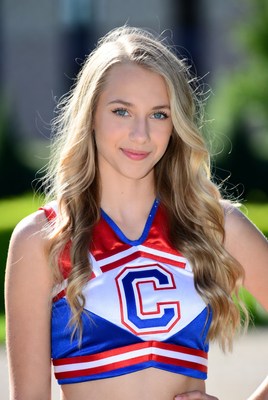 Cheerleader in vibrant uniform outdoors