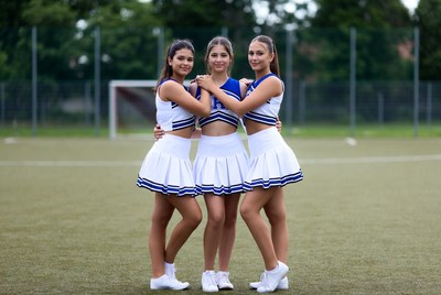 Cheerleaders celebrate on the field