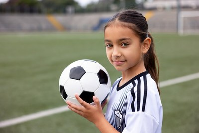 Young girl enjoys soccer practice