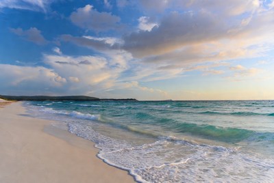 Serene beach at sunset with waves