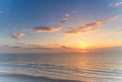 Sunset over calm ocean waves