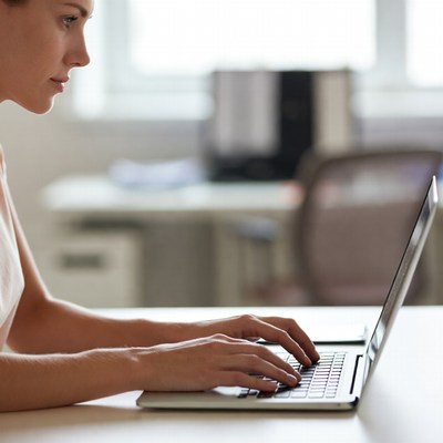 Woman working at laptop in office