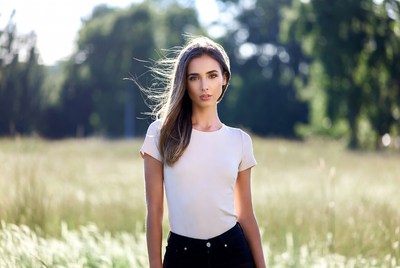 Model poses in sunlit field
