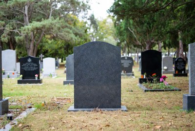 Calm cemetery with memorial stones and greenery