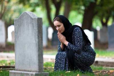 Woman mourning at a grave