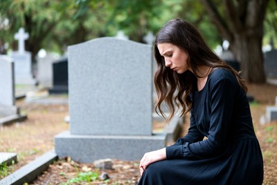 Woman mourning at cemetery site
