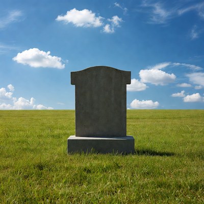 Simple gravestone in open field