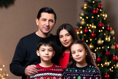 Family holiday portrait by the tree