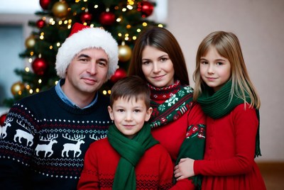 Festive family portrait by christmas tree