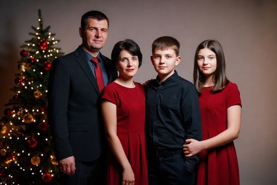 Family portrait by christmas tree