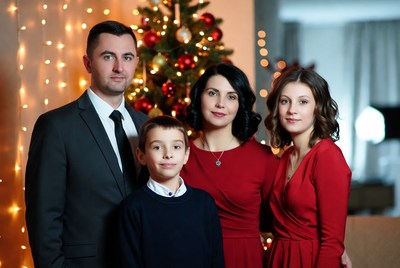 Family portrait by christmas tree