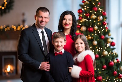 Family portrait by christmas tree