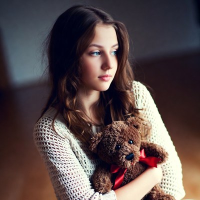 Young girl holding teddy bear