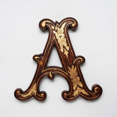 Decorative wooden letter a with gold accents