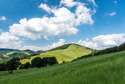 Rolling green hills under cloudy sky