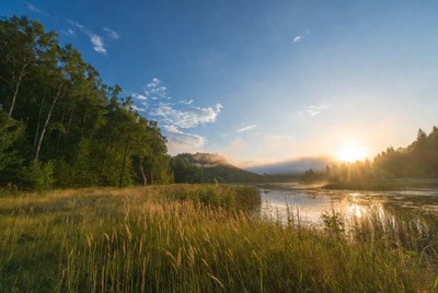 Sunrise over misty lake landscape