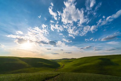 Rolling hills under bright sky