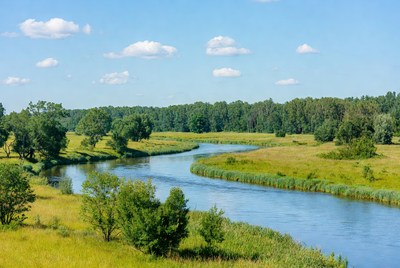 Serene river winding through green fields