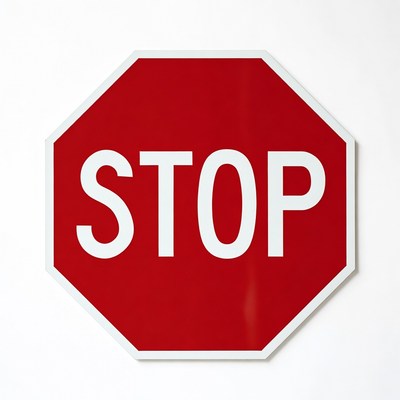 Red stop sign on a white wall