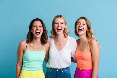 Friends enjoying laughter against blue background