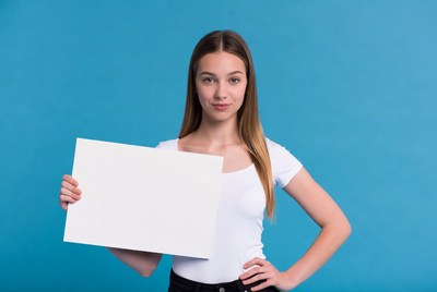 Young woman holding blank sign