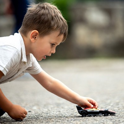 Young boy plays with toy car