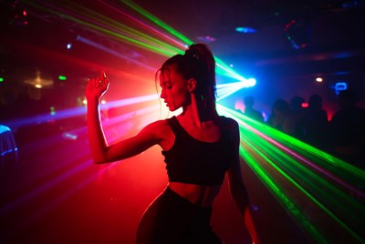 Dancer in colorful laser lights