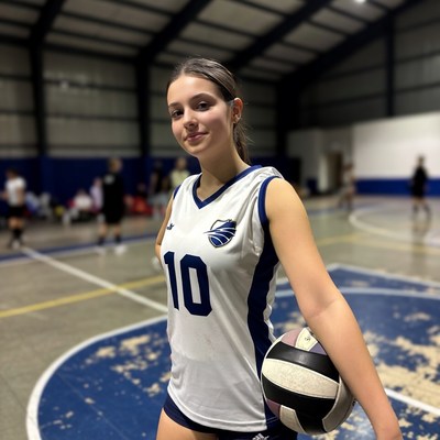 Female volleyball player with ball in gym