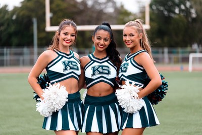 Cheerleaders pose at school field