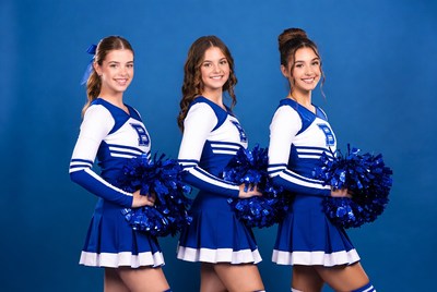 Cheerleaders in blue uniforms posing