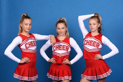 Cheerleaders pose in red uniforms