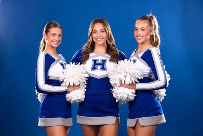 Cheerleaders with pompoms in blue backdrop