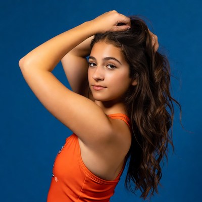 Model posing against blue backdrop