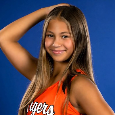 Smiling cheerleader in team uniform