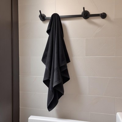 Black towel hanging in bathroom