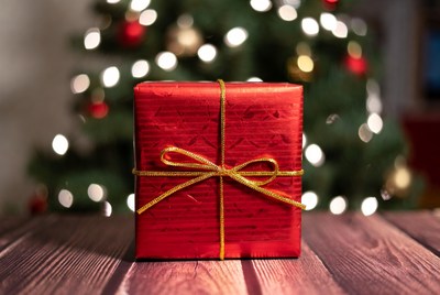 Wrapped gift beside christmas tree