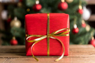 Festive red gift under tree