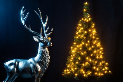 Silver reindeer and glowing christmas tree