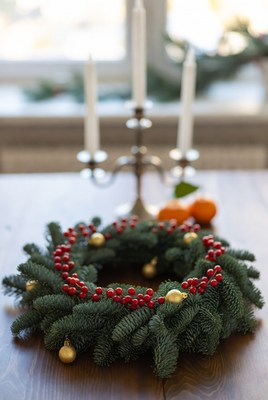 Christmas wreath with decorations on table