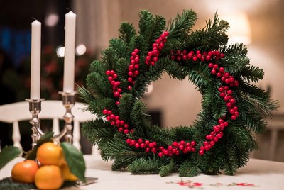Festive wreath with candles and fruit