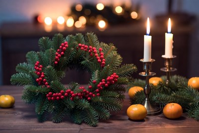Festive wreath with candles and oranges