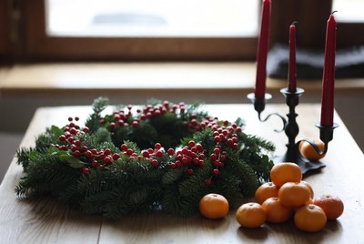 Holiday wreath with oranges and candles