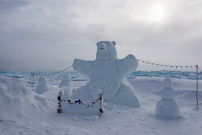Polar bear snow sculpture in winter landscape