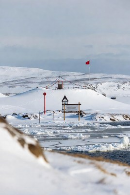 Arctic landscape with red flag and snow