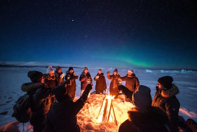 People gathered around fire at night