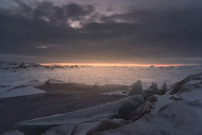 Snowy landscape under dark skies