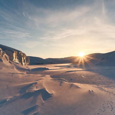 Winter sunset over snowy landscape