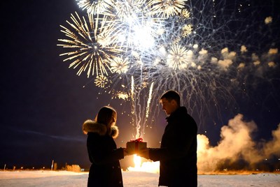 Couple celebrating with fireworks at night